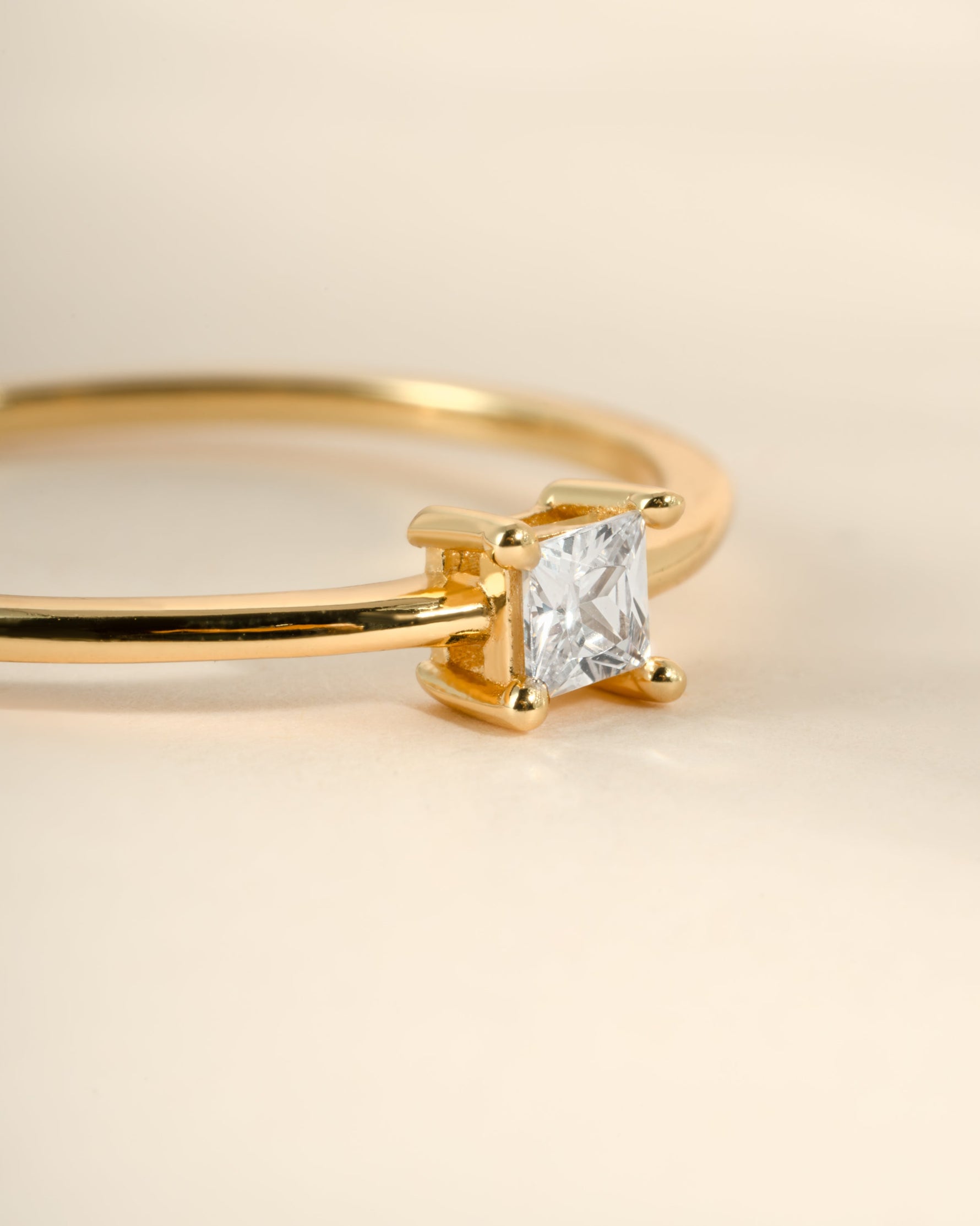 Close-up of Sami Jewels gold princess cut dainty ring showcasing a sparkling princess-cut gemstone and delicate band.