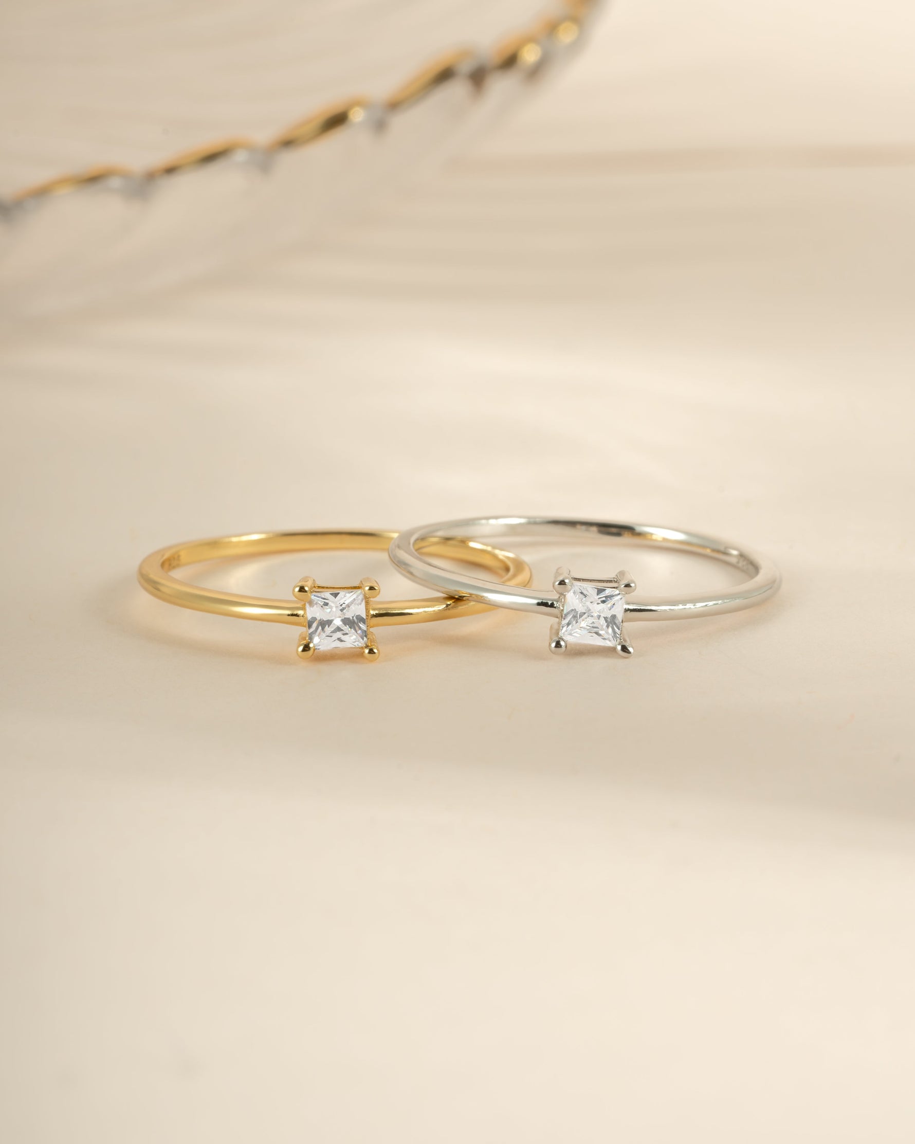 Dainty princess cut ring by Sami Jewels featuring a gold and sterling silver design, showcasing a sparkling princess-cut gemstone.