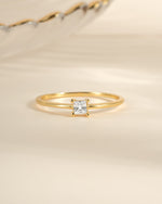 Gold princess-cut dainty ring from Sami Jewels featuring a sparkling square-shaped gemstone, elegant and perfect for everyday wear.