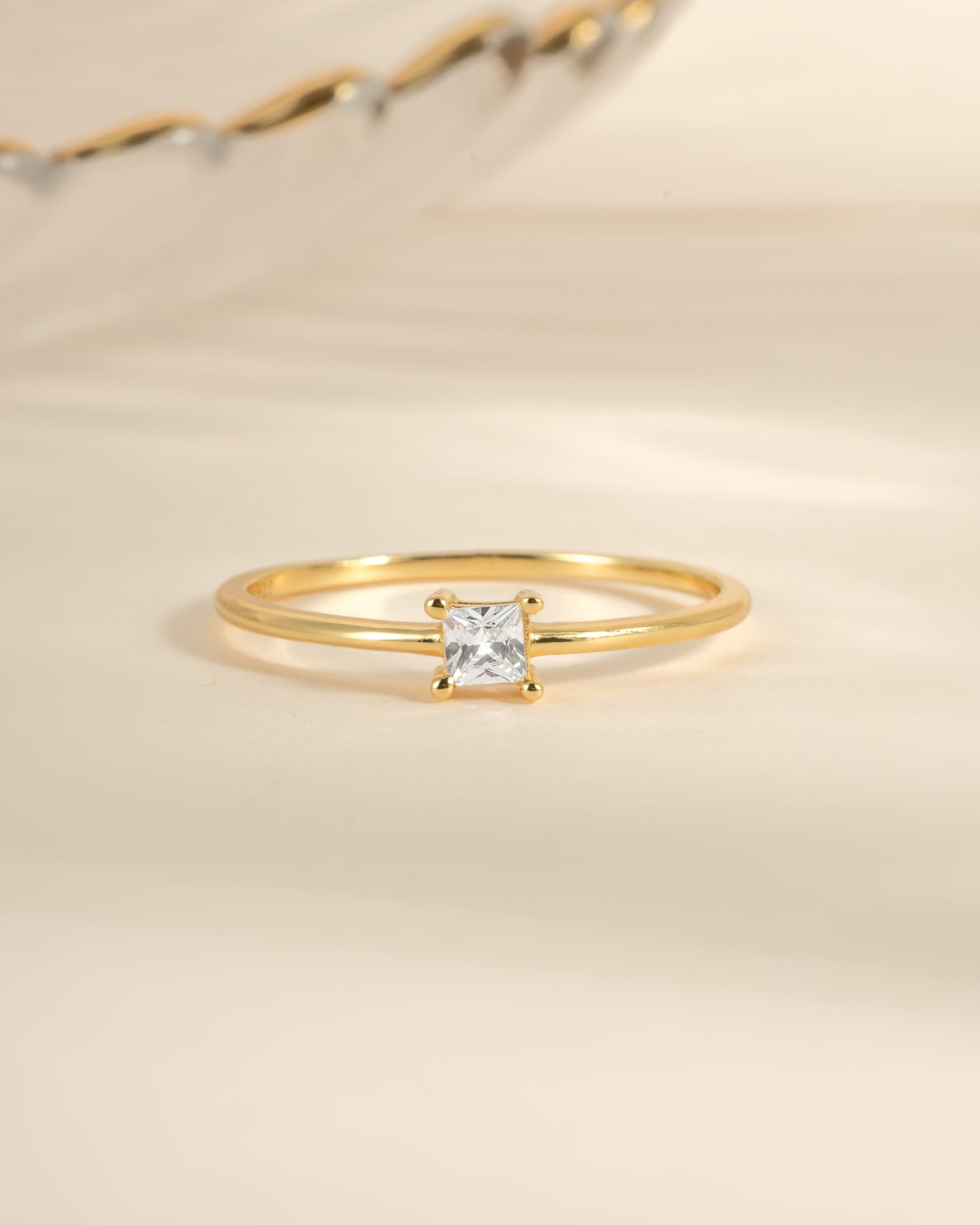 Gold princess-cut dainty ring from Sami Jewels featuring a sparkling square-shaped gemstone, elegant and perfect for everyday wear.