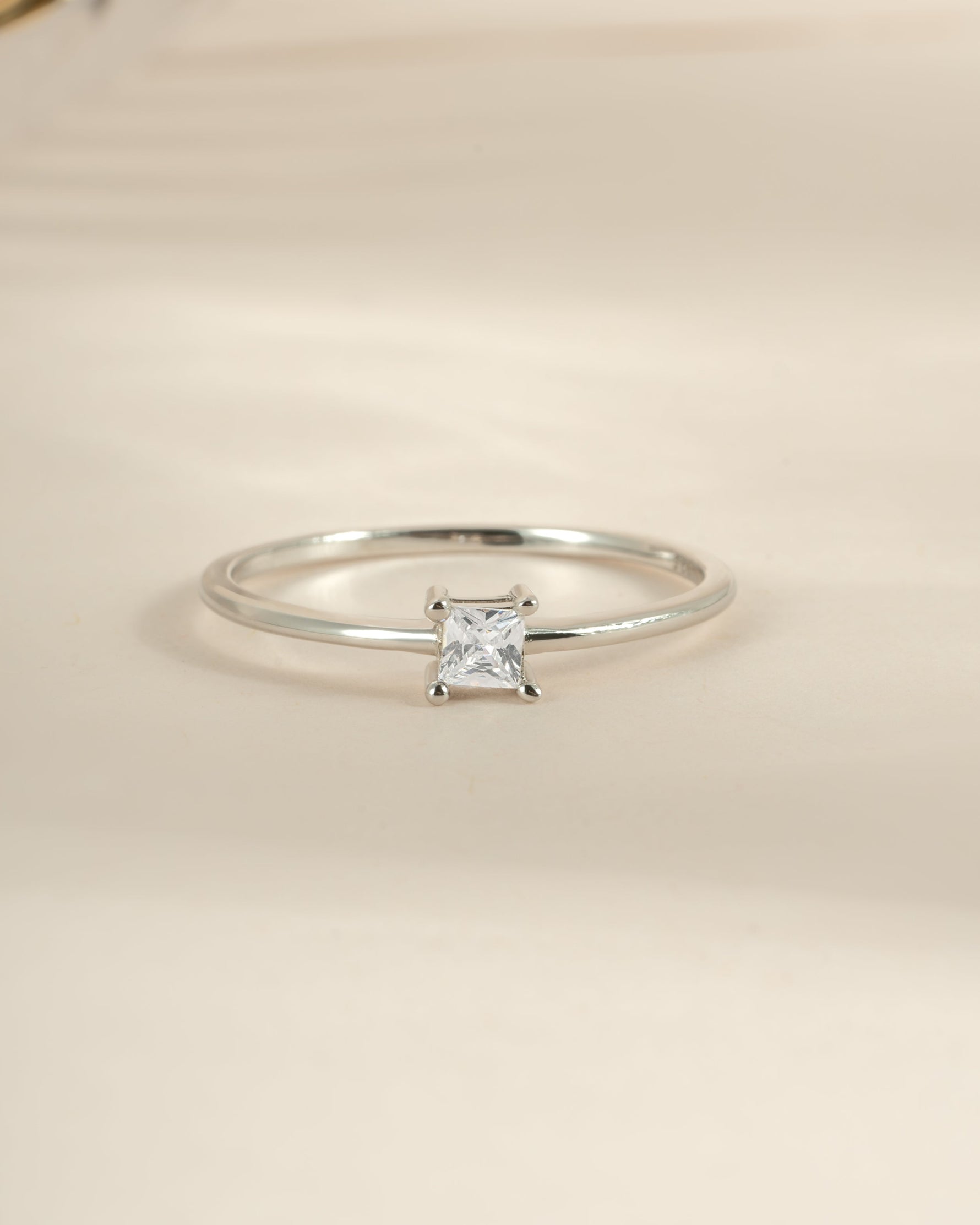 Sterling silver princess cut dainty ring by Sami Jewels, featuring a sparkling rectangular gemstone on a delicate band.