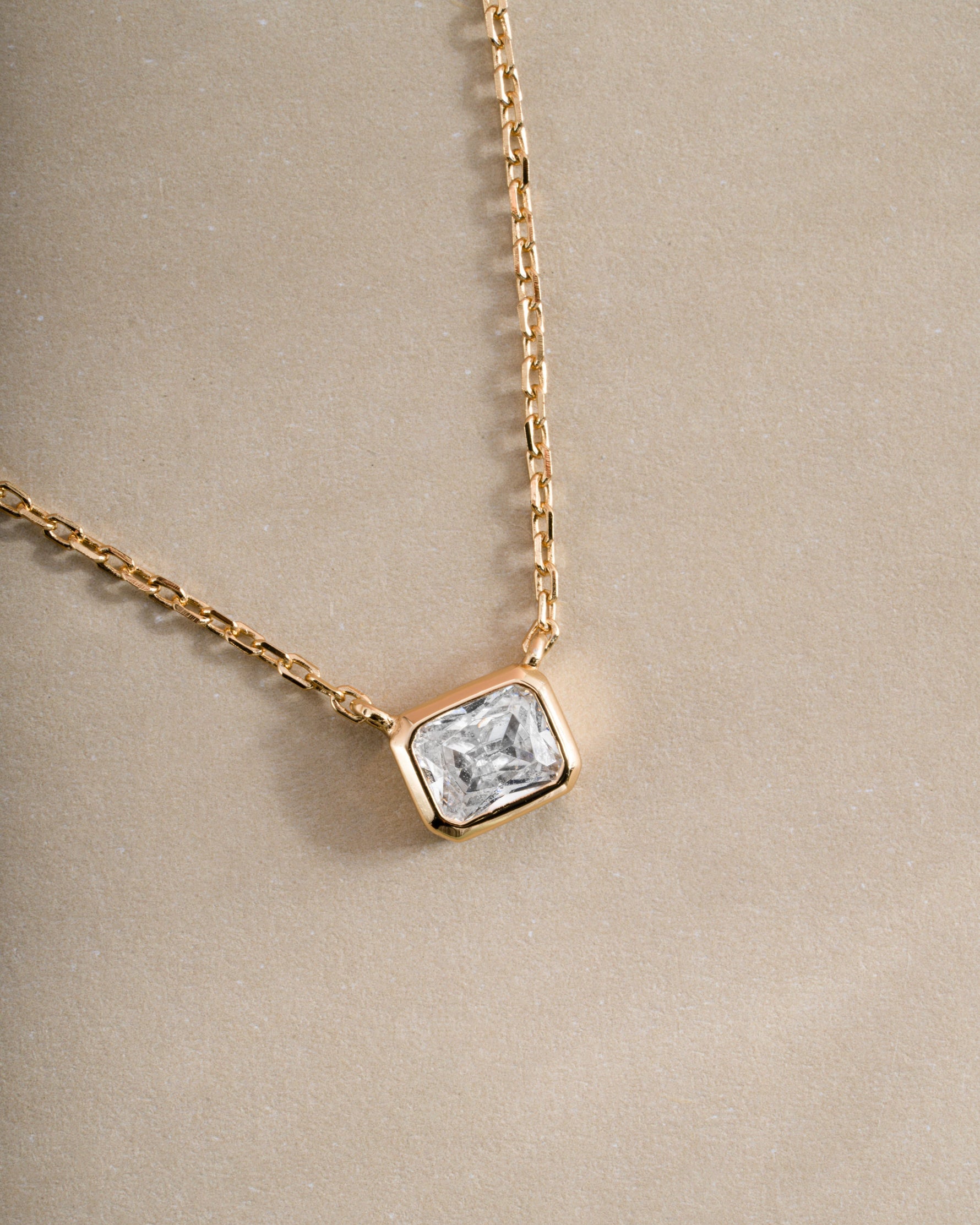 Close-up of Sami Jewels Radiant Bezel Necklace in gold, showcasing its elegant design and sparkling bezel setting.