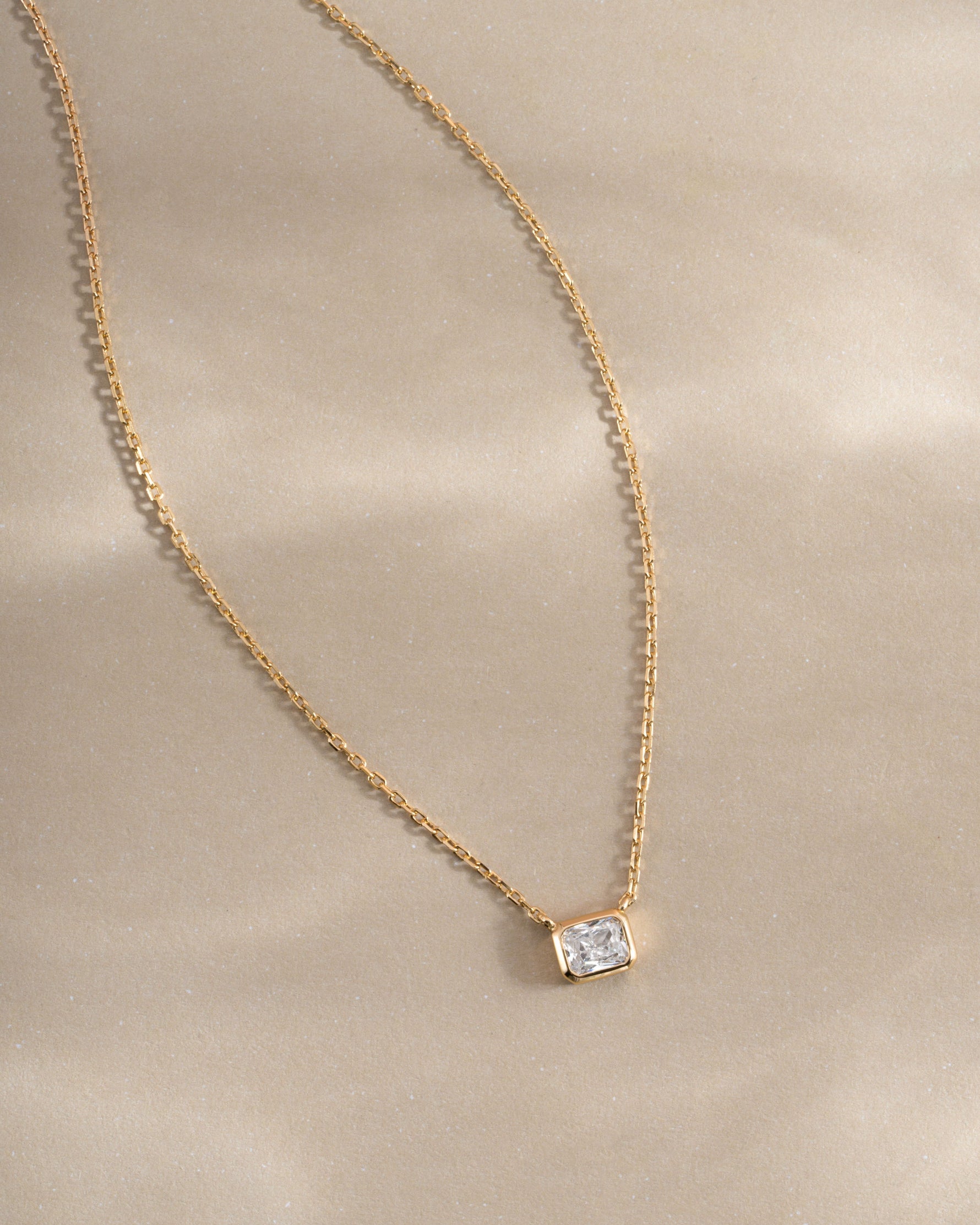 Golden Radiant Bezel Necklace by Sami Jewels featuring a sleek, elegant design with a radiant bezel pendant on a delicate chain.