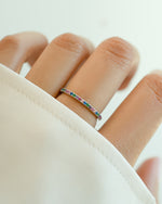 Sami Jewels rainbow eternity ring with colorful gemstone in sterling silver, showcasing a continuous rainbow design.