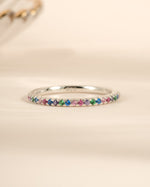 Sterling silver Rainbow Eternity Ring with colorful rainbow gemstones, crafted by Sami Jewels, showcasing vibrant, continuous design.