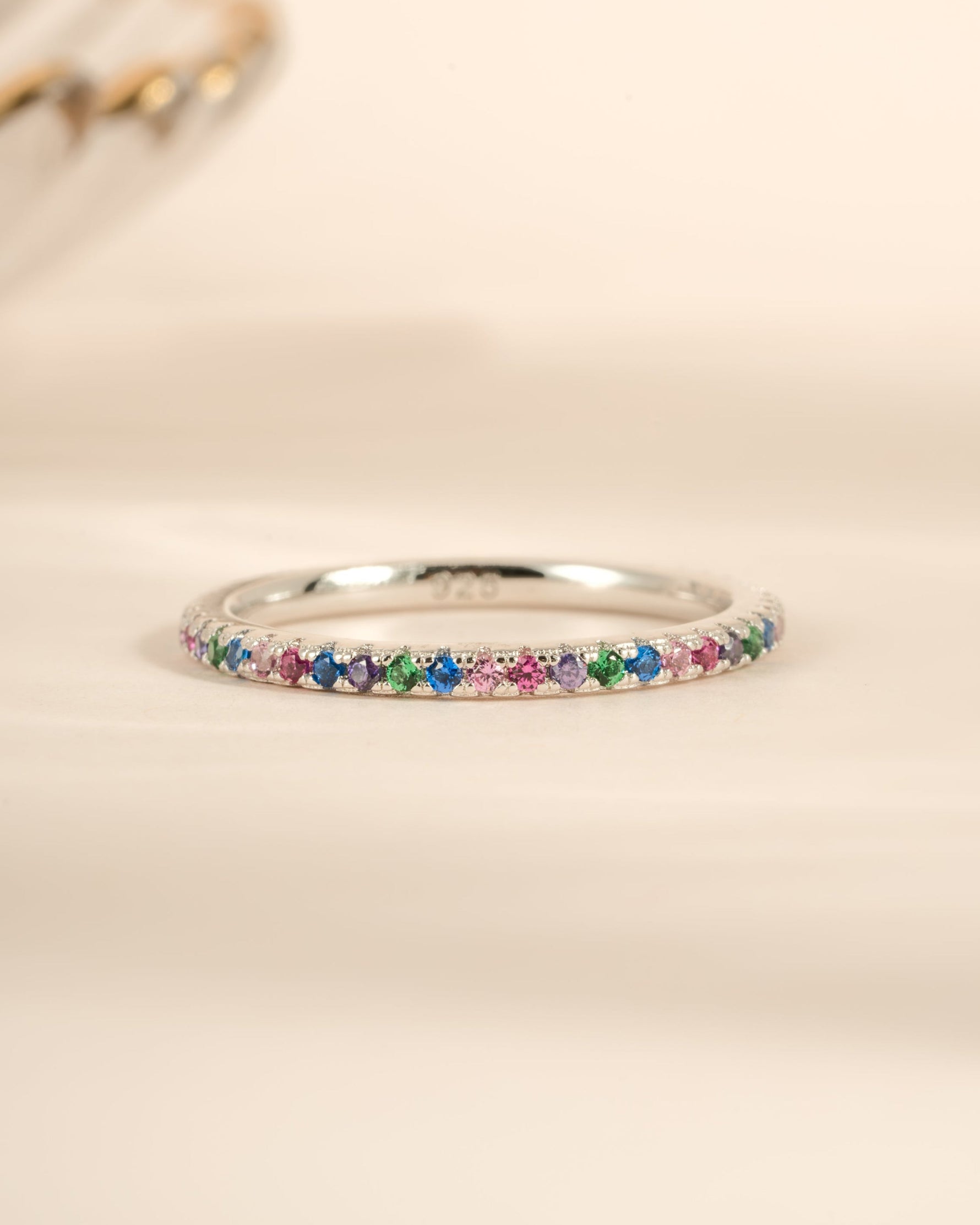 Sterling silver Rainbow Eternity Ring with colorful rainbow gemstones, crafted by Sami Jewels, showcasing vibrant, continuous design.