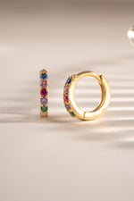 Gold 7mm Rainbow Huggie Earrings with colorful rainbow-studded design from Sami Jewels