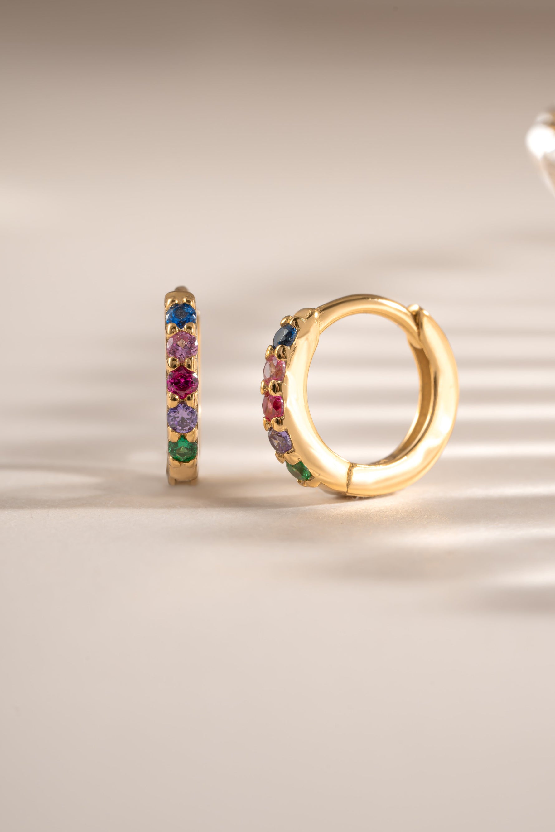 Gold 7mm Rainbow Huggie Earrings with colorful rainbow-studded design from Sami Jewels
