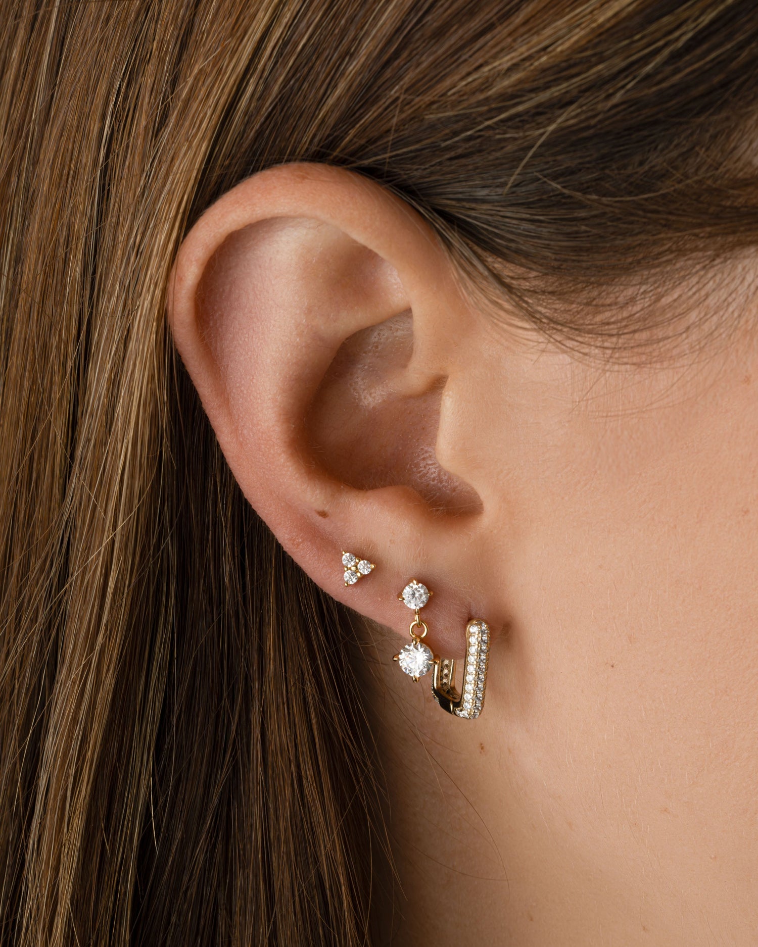 Gold rectangle diamond Huggies earrings by Sami Jewels with a modern, sleek design on a model.