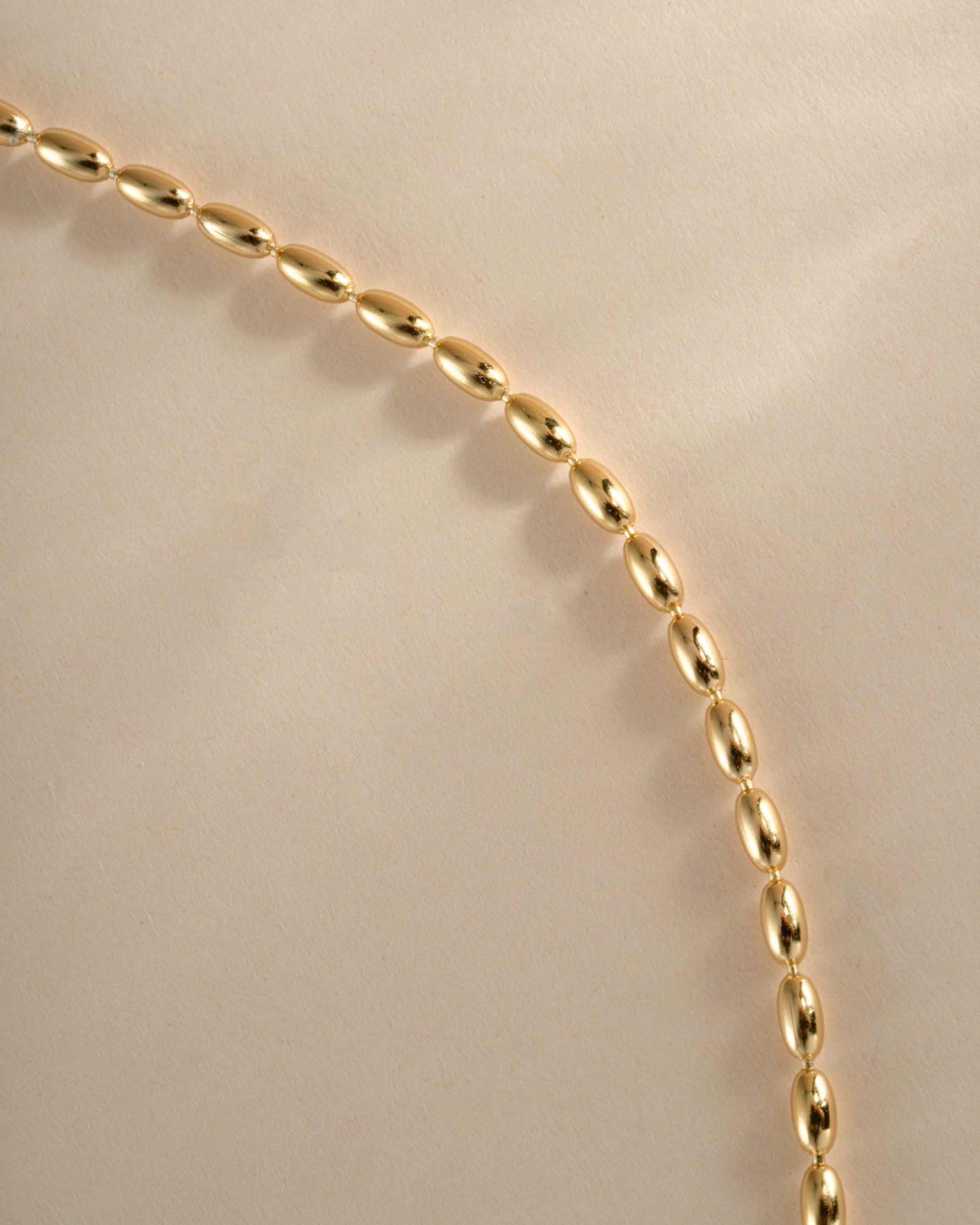 Close-up of Sami Jewels gold rice bead necklace showcasing its delicate texture and intricate bead design.