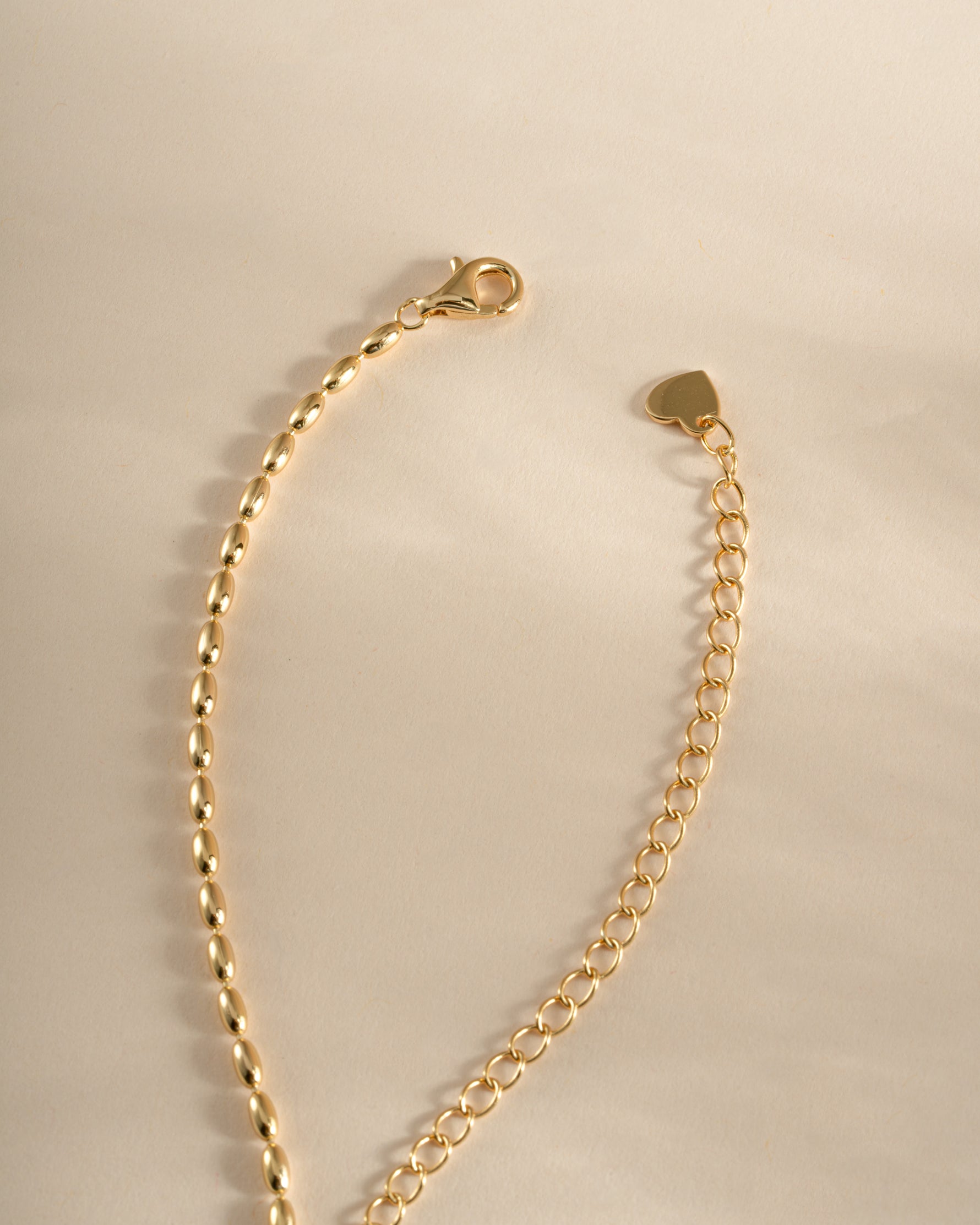Gold rice bead necklace with lobster clasp by Sami Jewels, featuring small, uniform rice-shaped beads on a delicate chain.