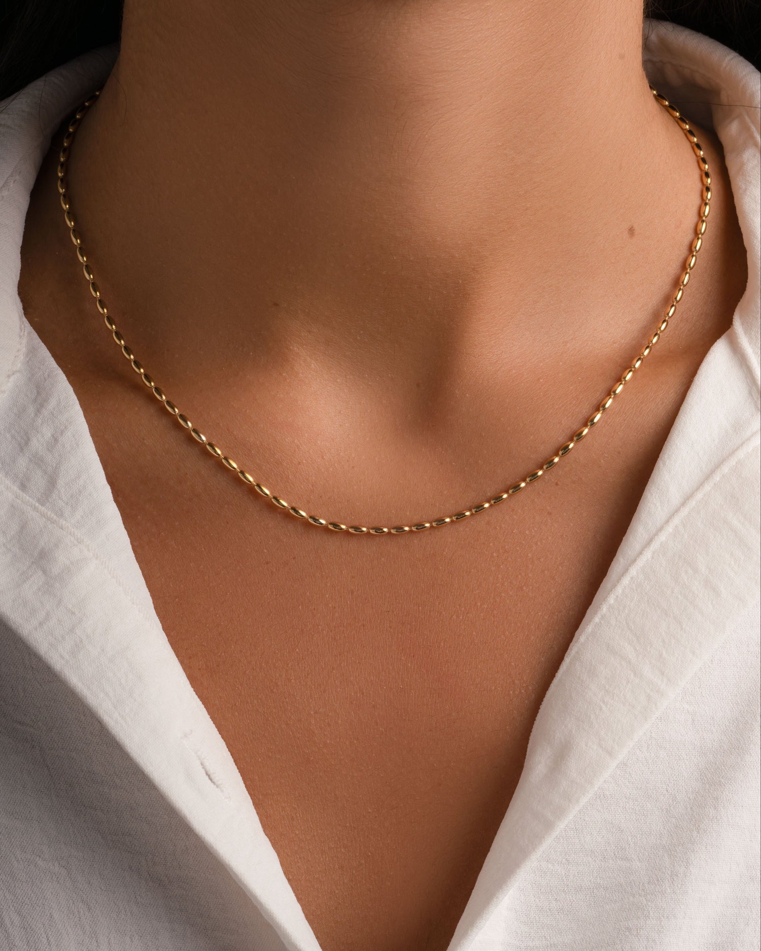 Gold Rice Bead Necklace from Sami Jewels, featuring delicate rice beads on a stylish necklace, worn by a model.