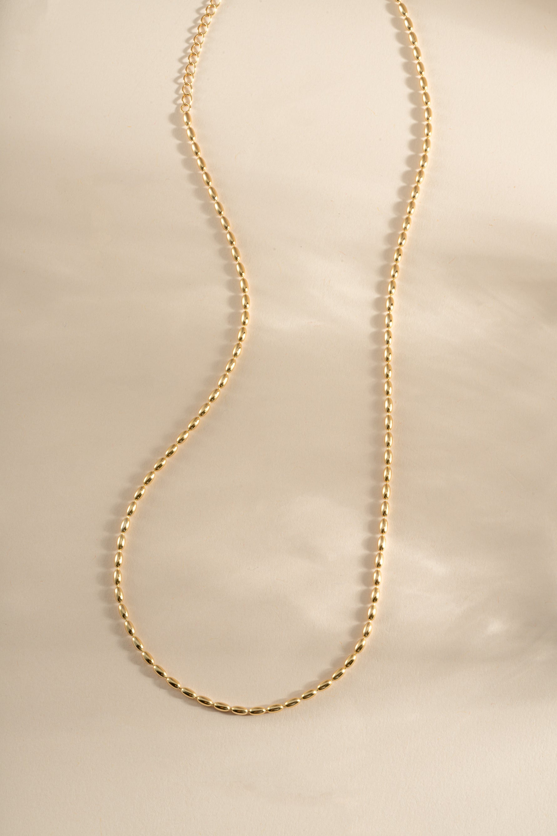 Gold Rice Bead Necklace from Sami Jewels featuring a delicate string of small rice-shaped beads.