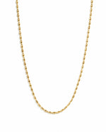 Gold rice bead necklace by Sami Jewels displayed on a white background, showcasing its elegant design and delicate craftsmanship.