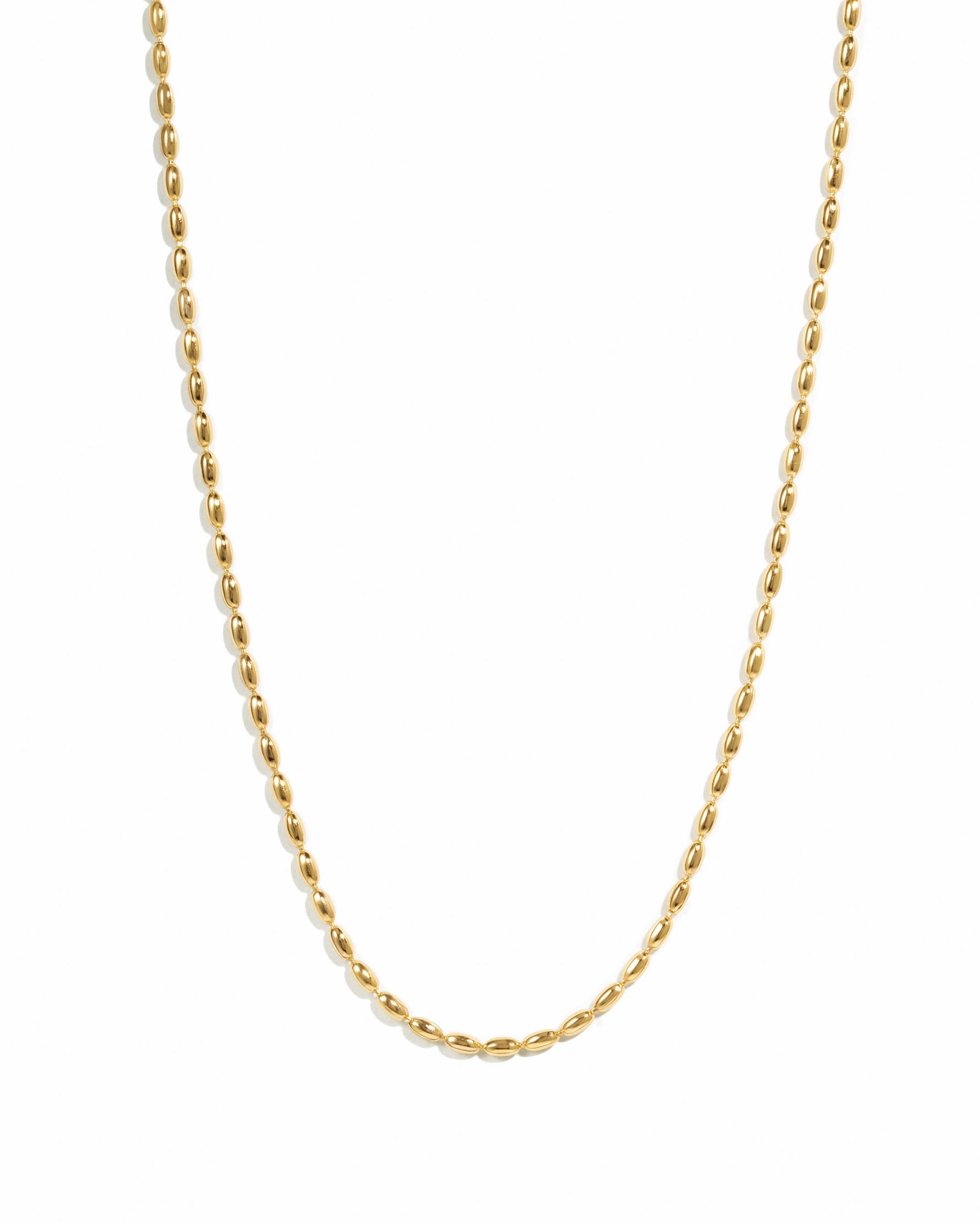 Gold rice bead necklace by Sami Jewels displayed on a white background, showcasing its elegant design and delicate craftsmanship.