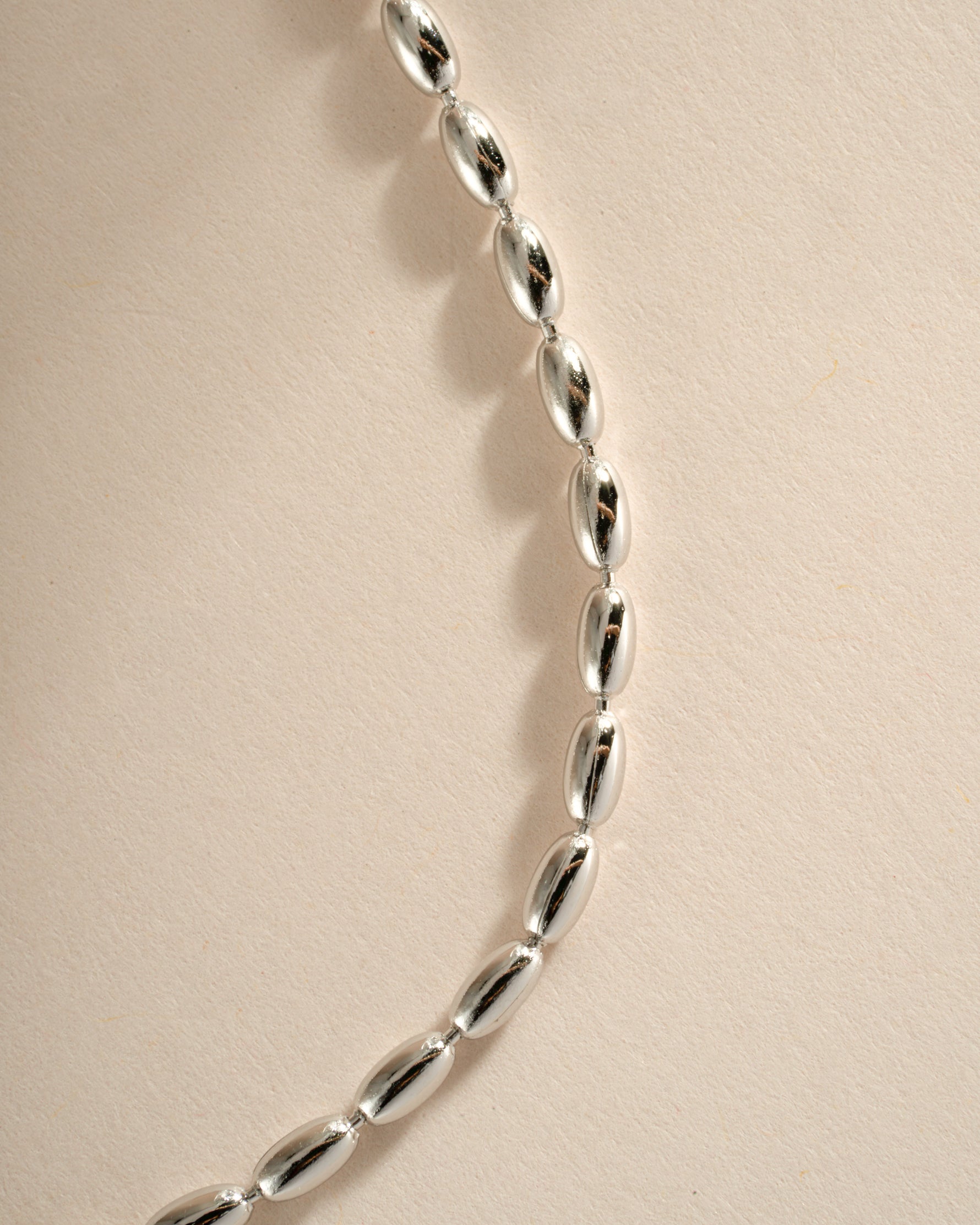 Close-up of Sami Jewels rice bead necklace made with sterling silver, showcasing intricate rice-shaped beads and detailed craftsmanship.