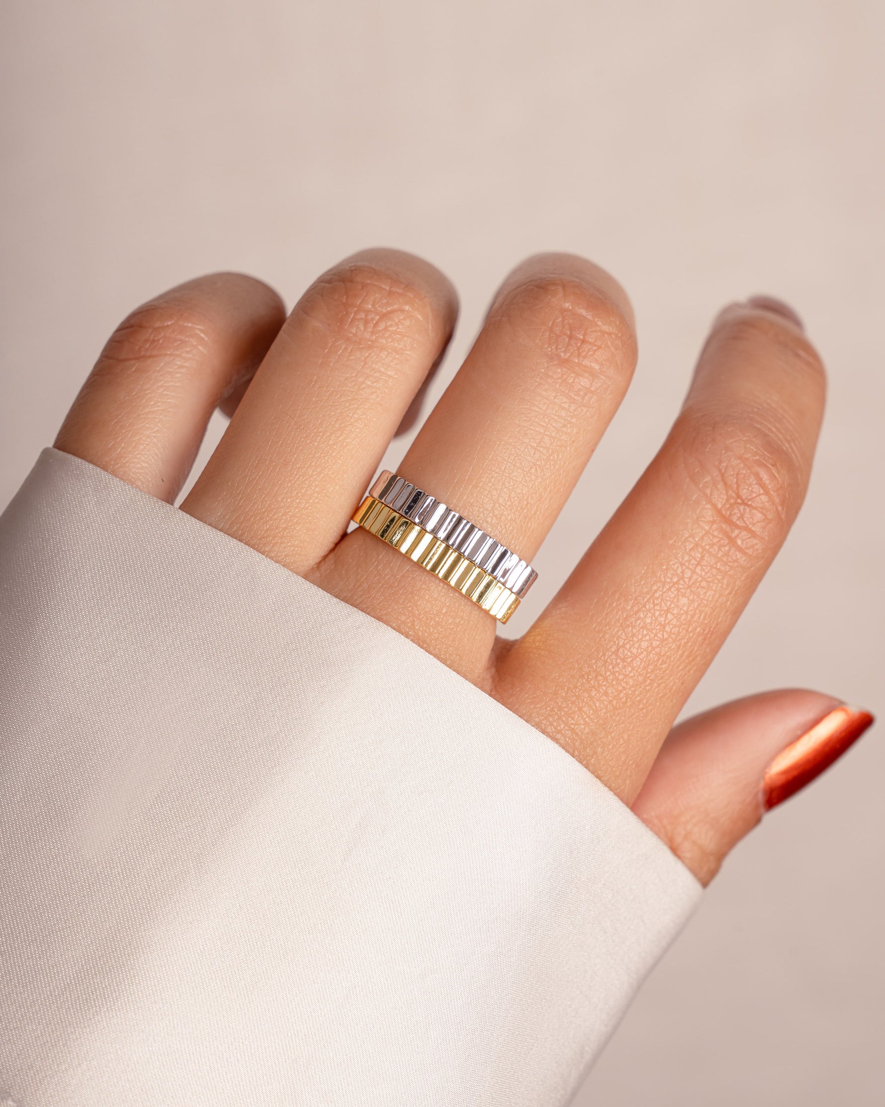 Gold and sterling silver ridged ring by Sami Jewels worn on a model's finger, showcasing its textured design and elegant style.