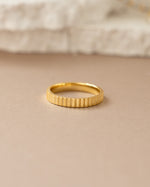 Close-up of a gold ridged ring by Sami Jewels showcasing textured surface and elegant design.