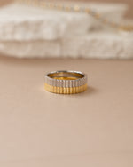 Stacked sterling silver and gold ridged rings by Sami Jewels, showcasing textured band designs and elegant craftsmanship.