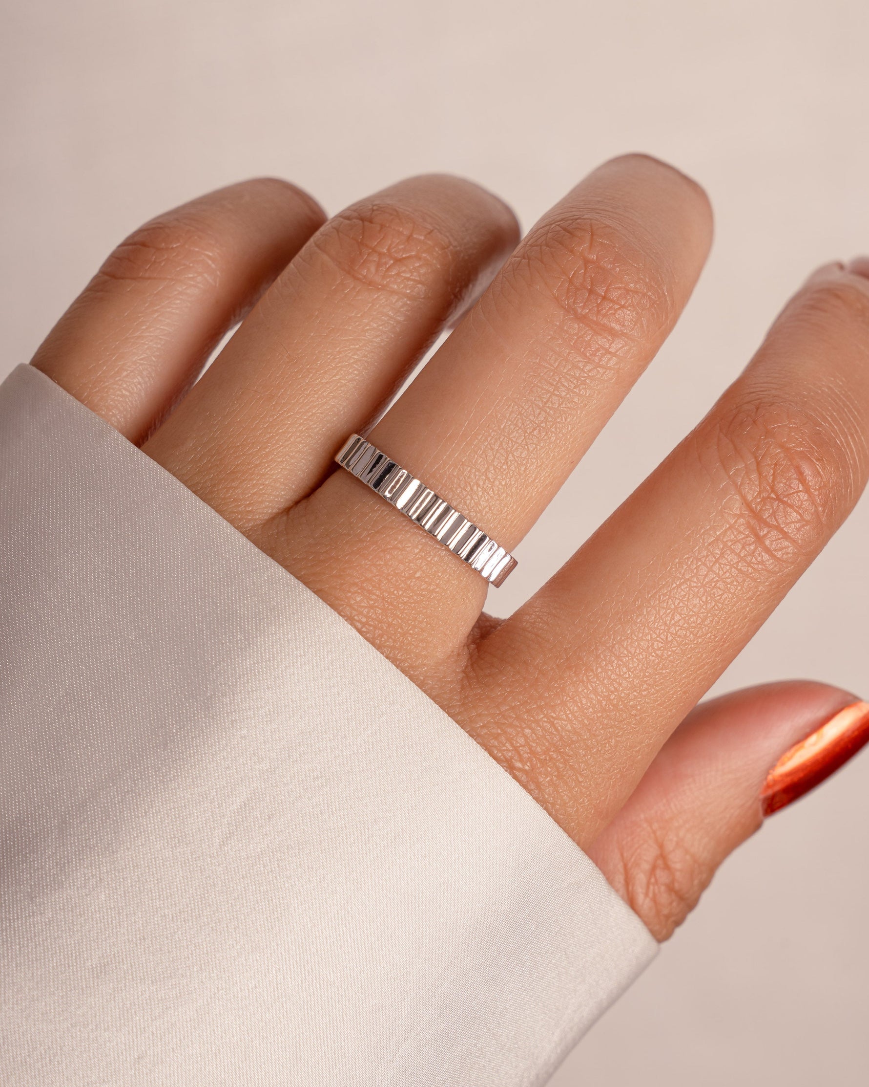 Sterling silver ridged ring from Sami Jewels with a textured, sculpted design, showcasing its detailed band and polished finish.