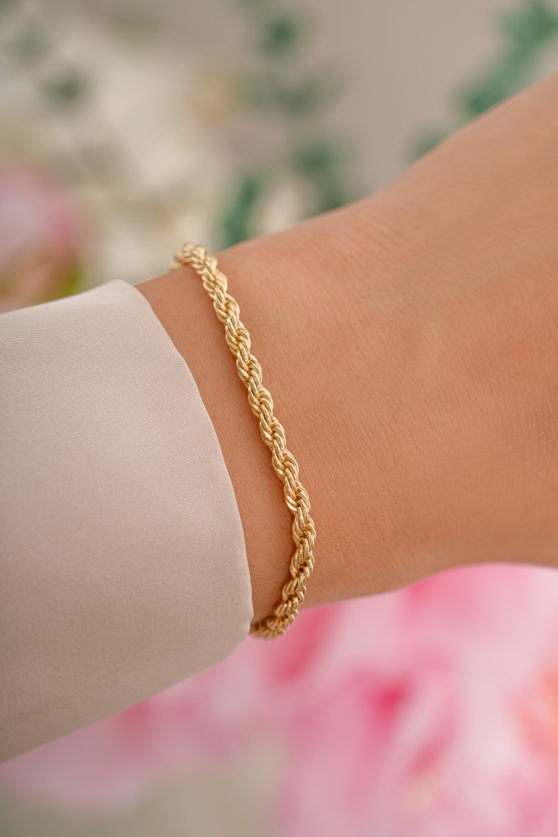 Gold Rope Chain Bracelet from Sami Jewels featuring a textured, twisted design on a model's wrist.