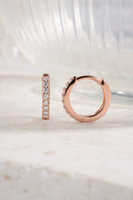 rose gold 11mm studded huggie hoop neutral background