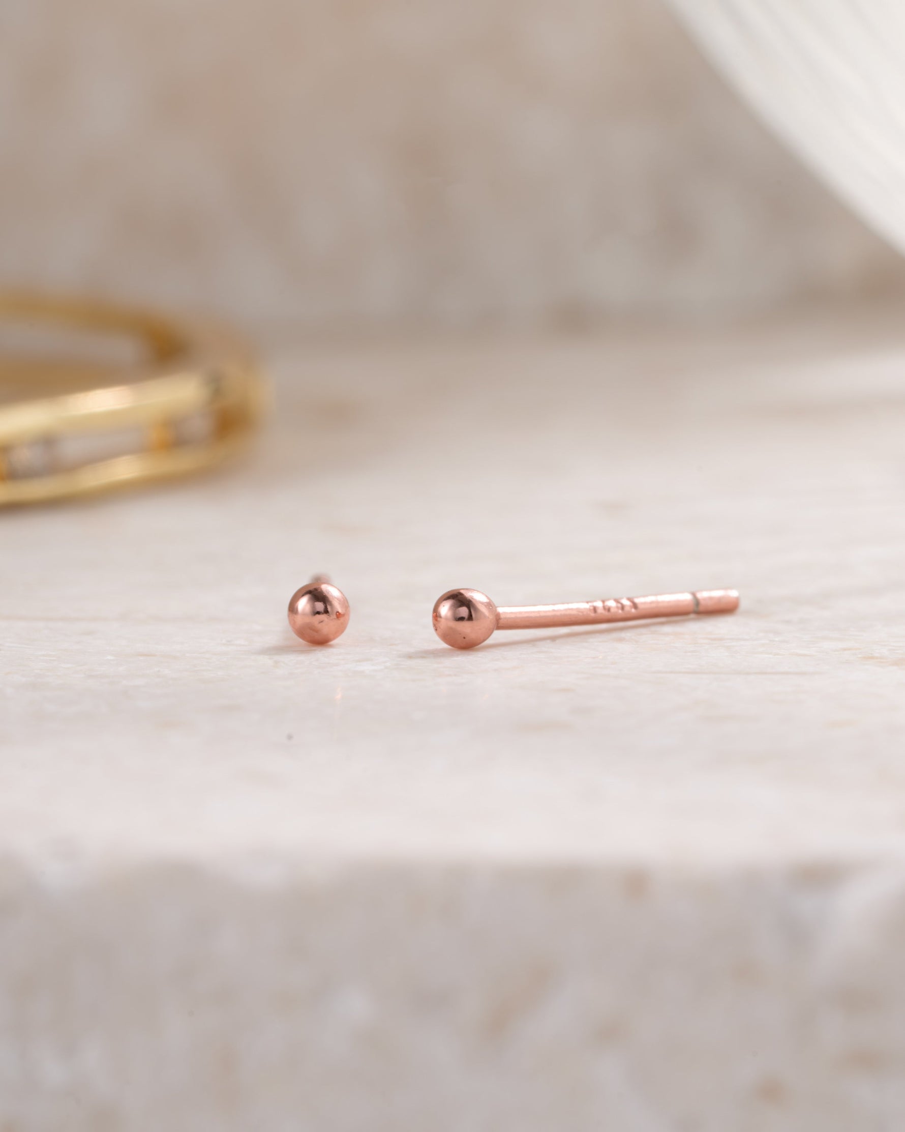 rose gold 2mm ball stud earring neutral background