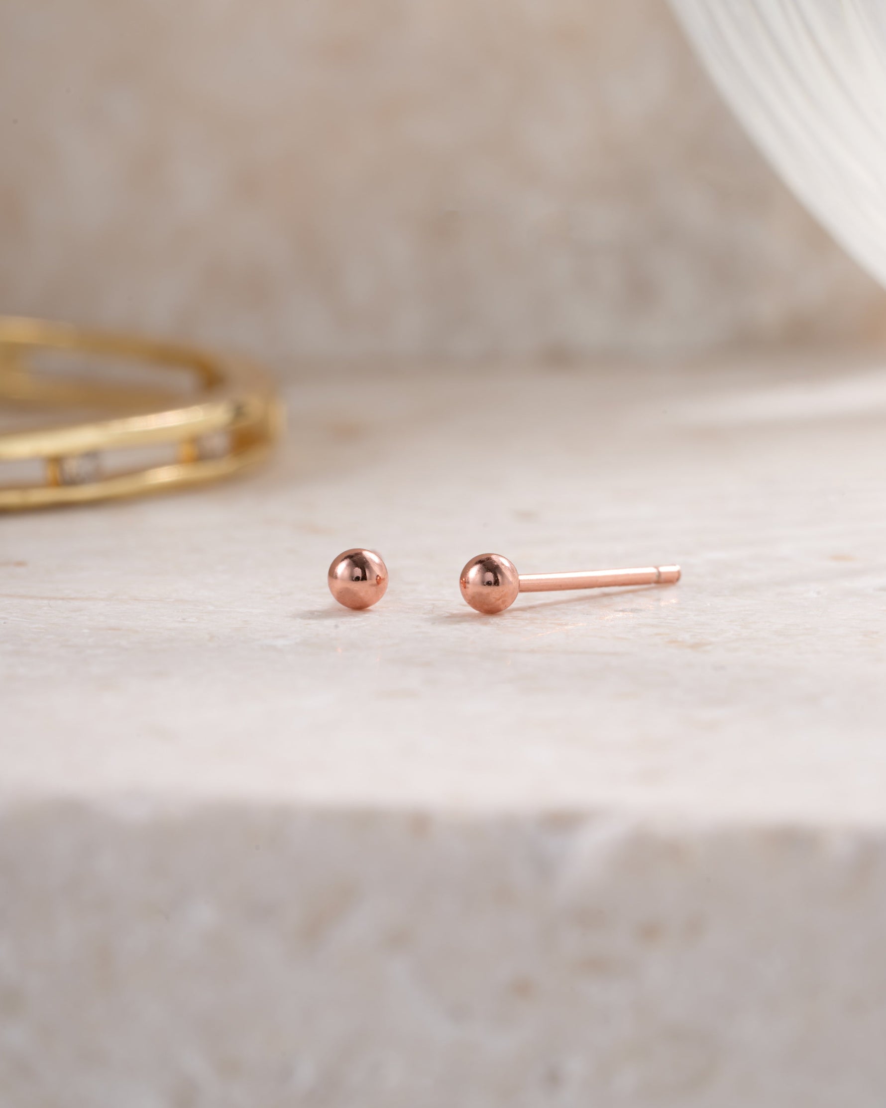 rose gold 3mm ball stud earring neutral background