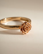 Gold rose ring from Sami Jewels, side view showing intricate floral design in a delicate, elegant jewelry piece.