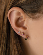 Gold Tiny Rose 3 Stone Stud Earrings by Sami Jewels, featuring delicate rose-shaped design and three sparkling stones.