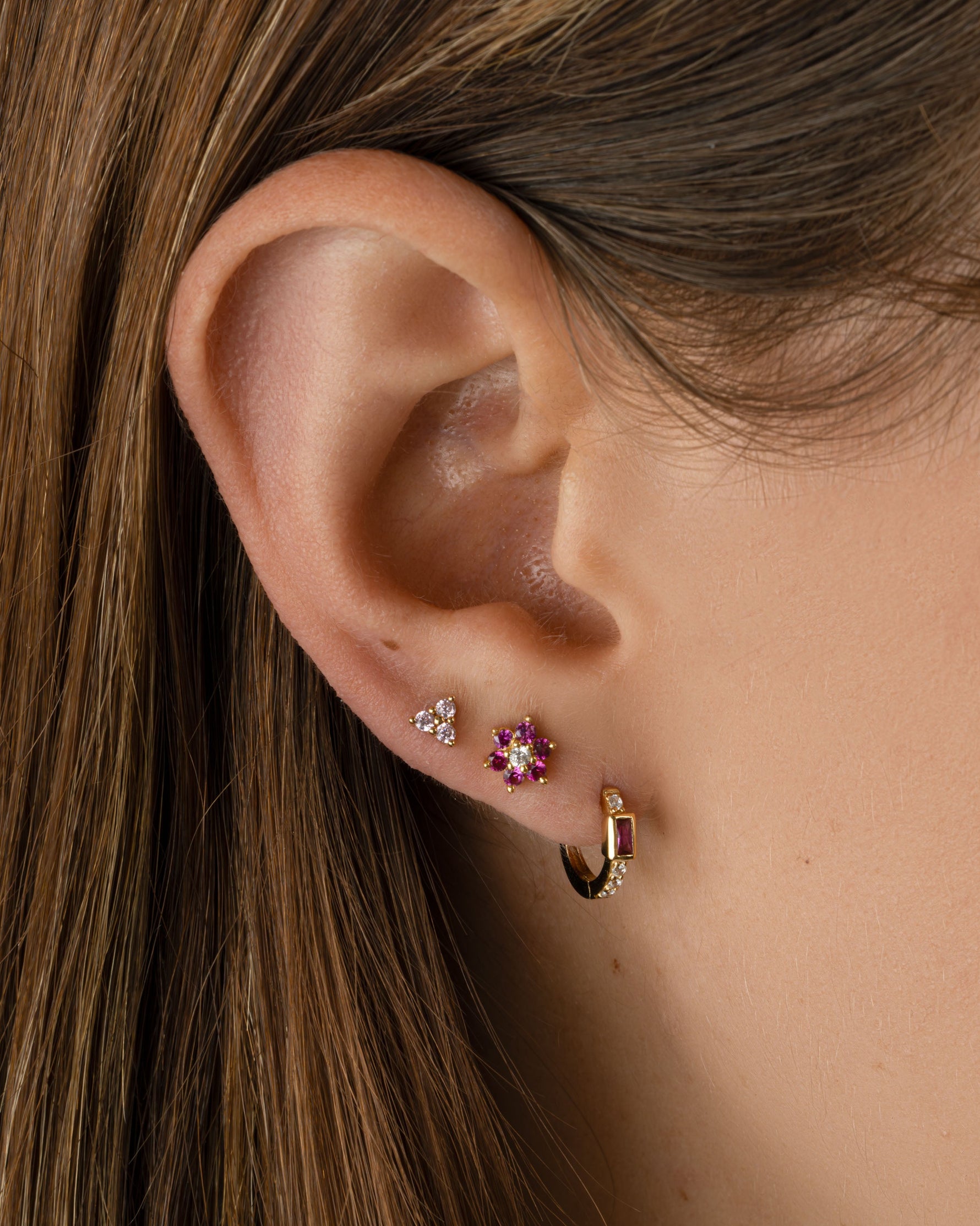Gold Tiny Rose 3 Stone Stud Earrings by Sami Jewels, featuring delicate rose-shaped design and three sparkling stones.