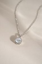 Round bezel pendant necklace from Sami Jewels, featuring a sleek circular design perfect for bridal or elegant occasions.