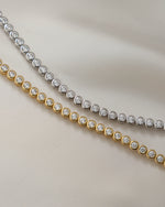 round bezel diamond tennis bracelet, 3mm in gold and silver closeup front view