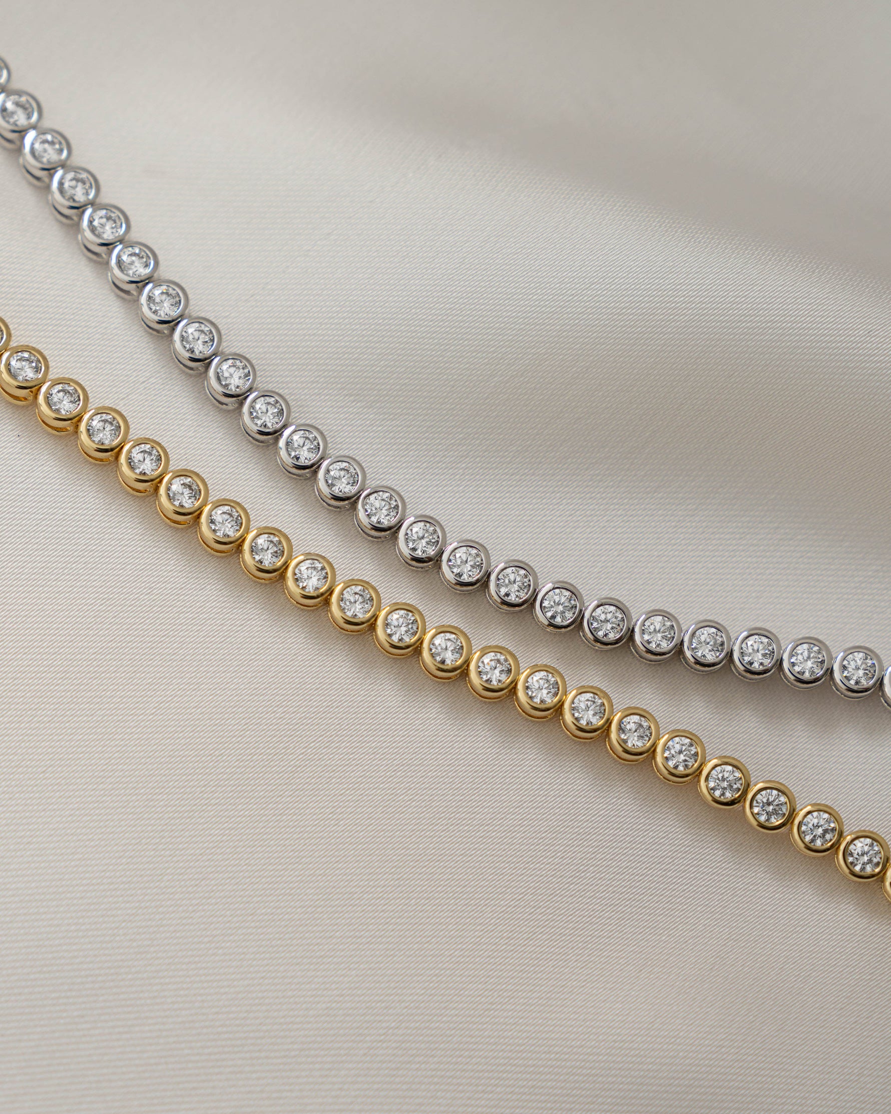 round bezel diamond tennis bracelet, 3mm in gold and silver closeup front view