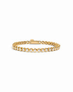 round bezel diamond tennis bracelet, 3mm in gold on a white background