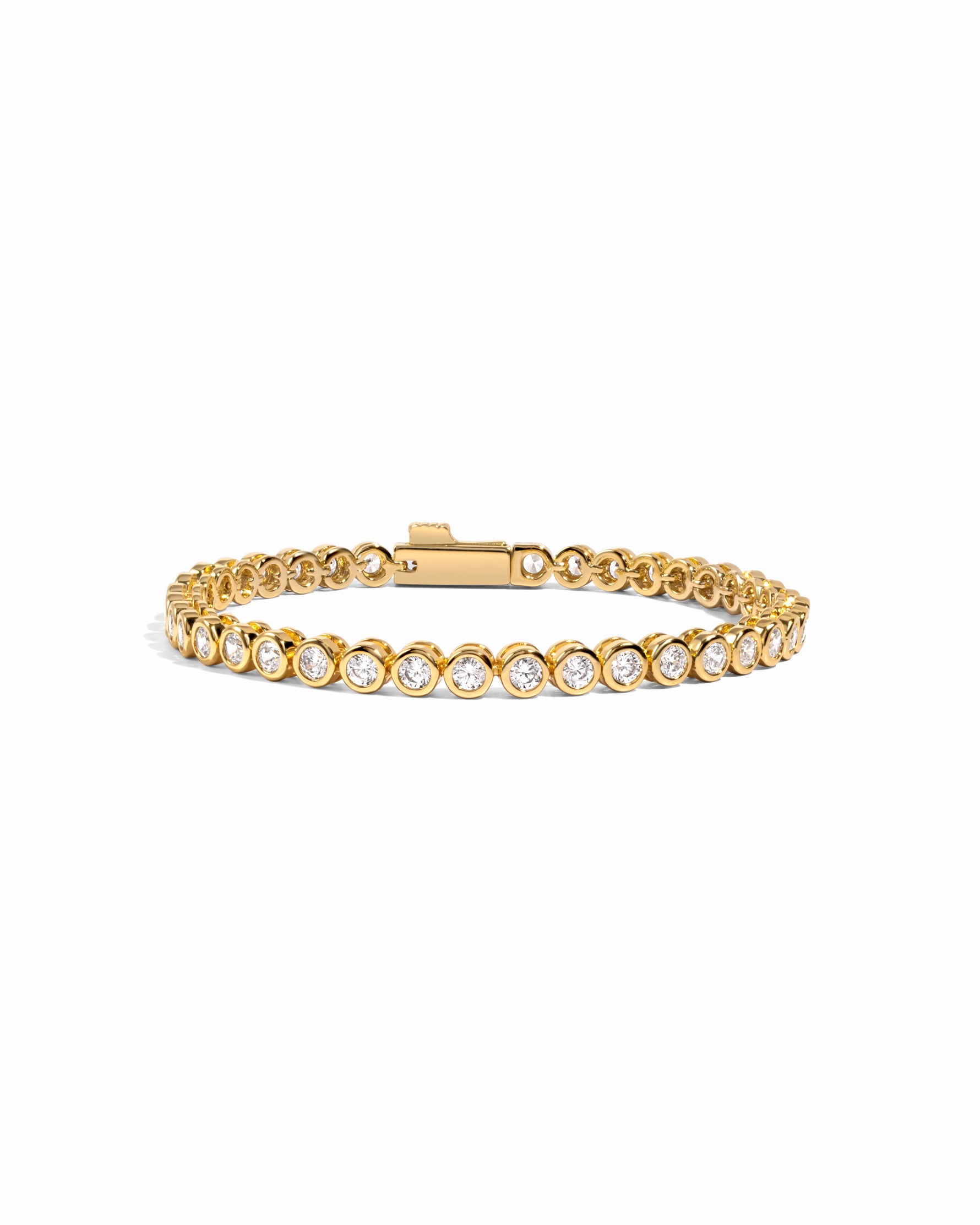 round bezel diamond tennis bracelet, 3mm in gold on a white background