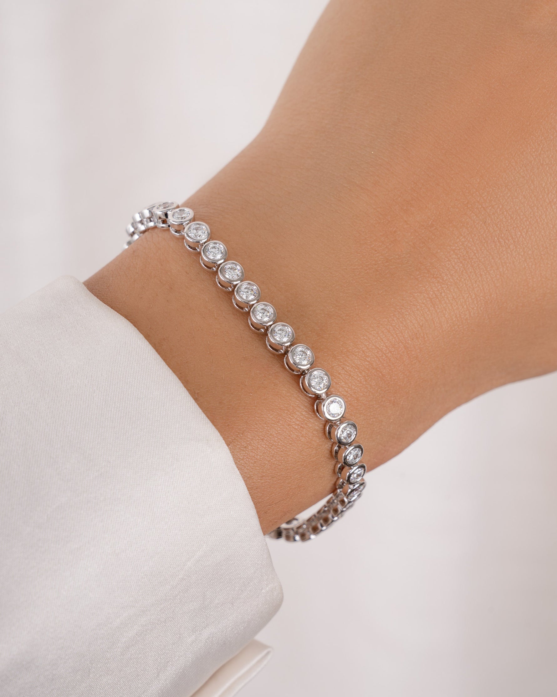 round bezel diamond tennis bracelet, 3mm in silver on a models wrist