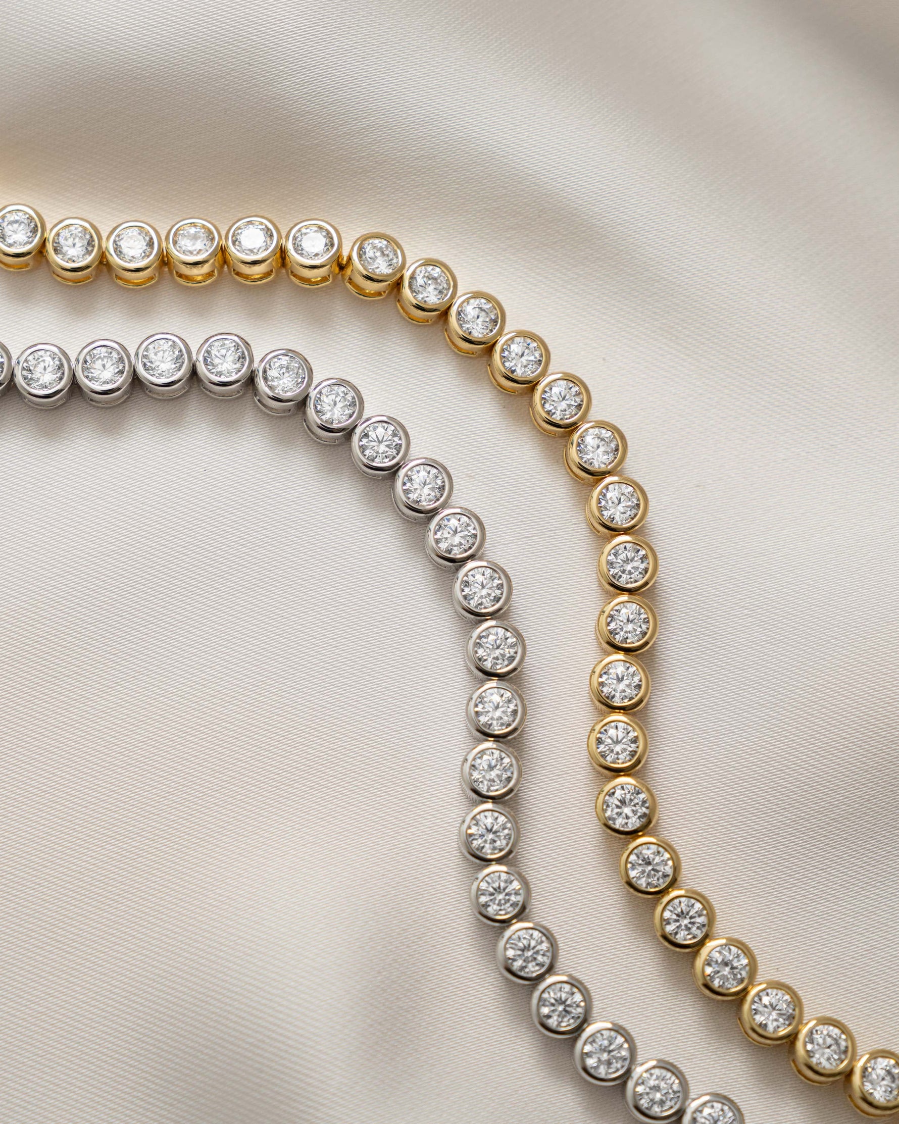 round bezel diamond tennis bracelet in 4mm gold and silver closeup view 