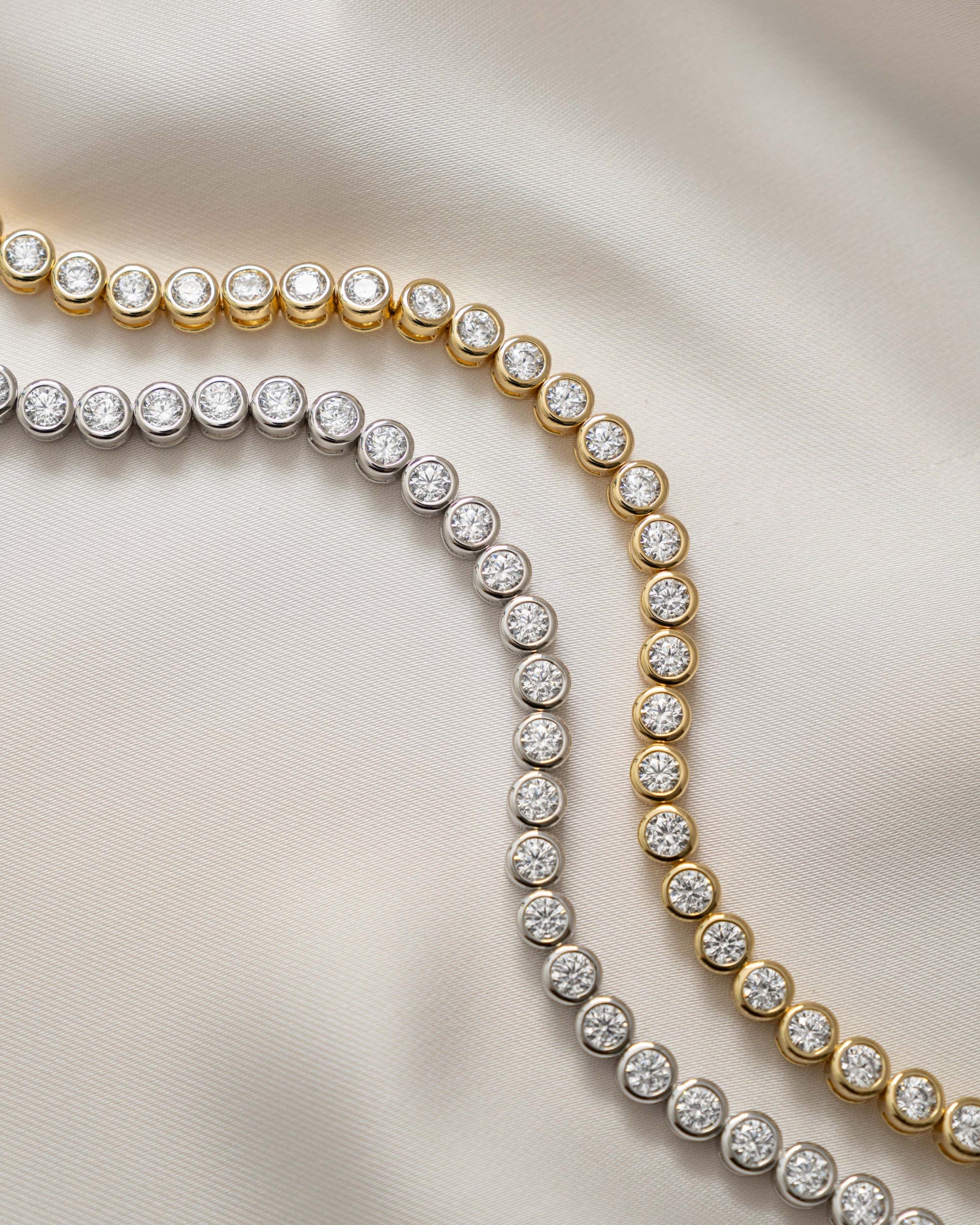 round bezel diamond tennis bracelet in 4mm gold and silver closeup view 
