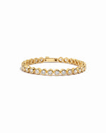 round bezel diamond tennis bracelet in 4mm gold on a white background