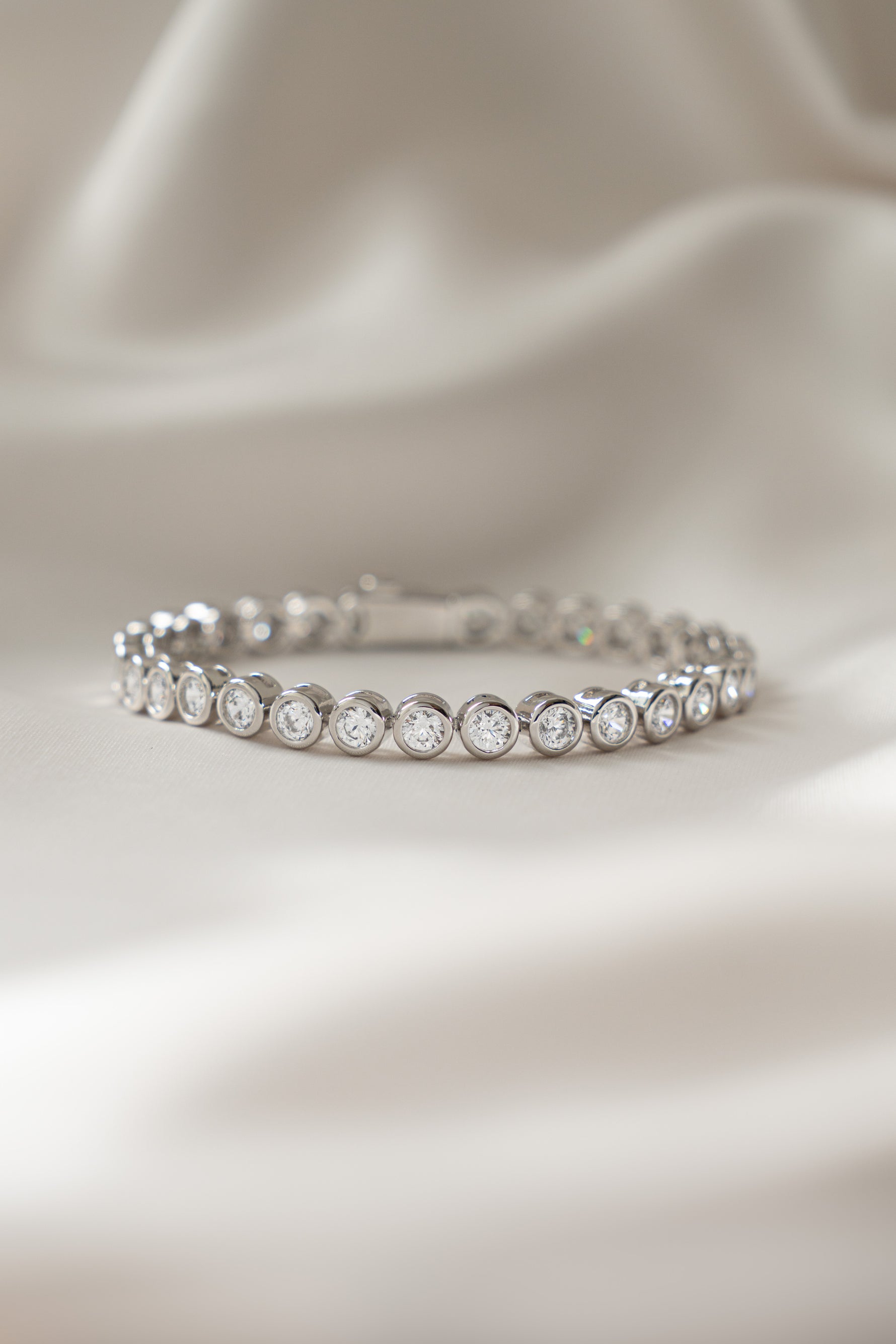round bezel diamond tennis bracelet in 4mm in silver closeup front view 