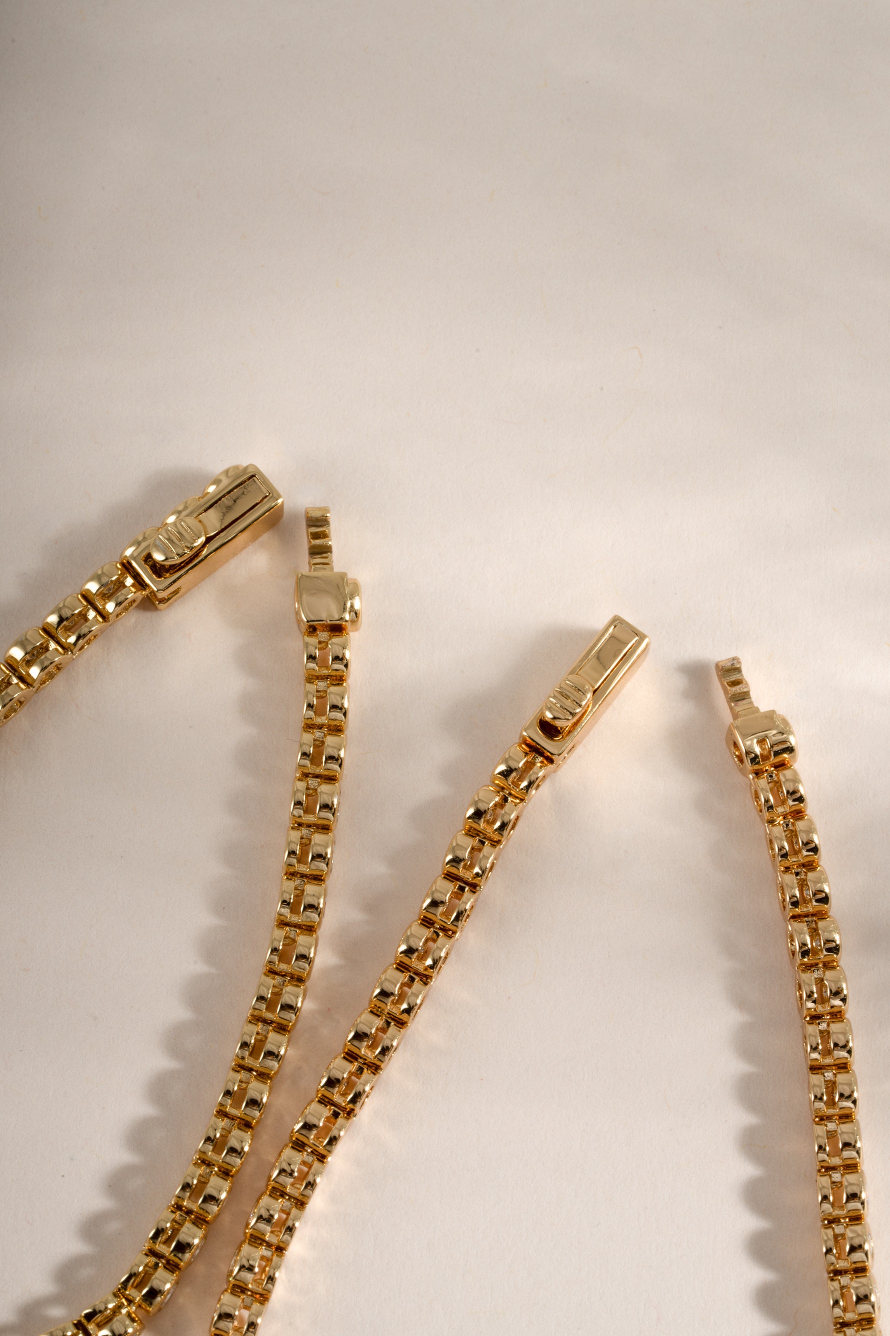 Gold round bezel tennis bracelet with box clasp closure by Sami Jewels, showcasing a sleek and elegant jewelry design.