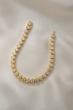 Gold 4mm round bezel tennis bracelet by Sami Jewels featuring a sleek, elegant design with polished round beads.
