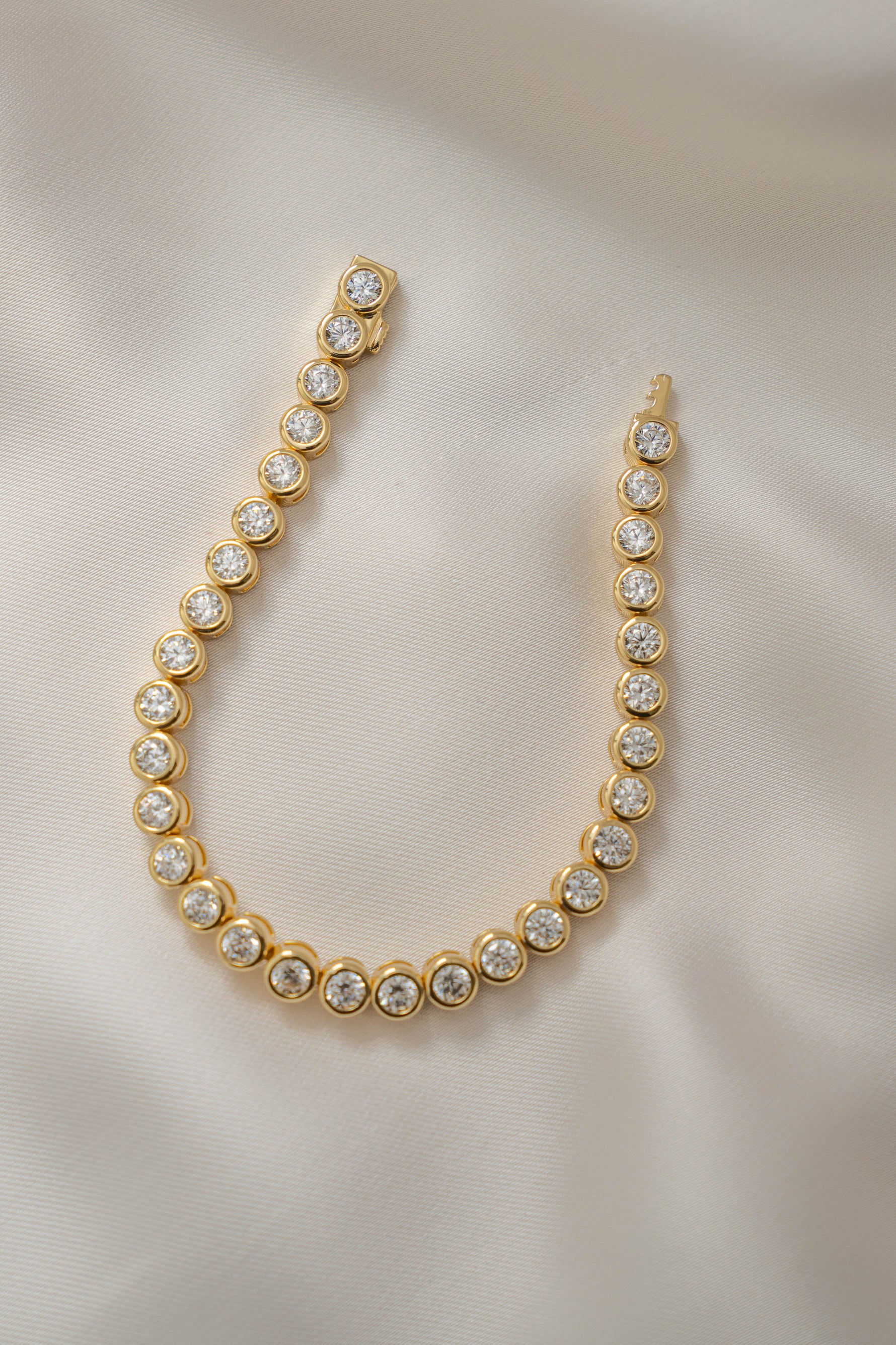 Gold 4mm round bezel tennis bracelet by Sami Jewels featuring a sleek, elegant design with polished round beads.