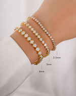 Gold 2.5mm round bezel tennis bracelet by Sami Jewels, featuring sleek, polished round links on a model's wrist.
