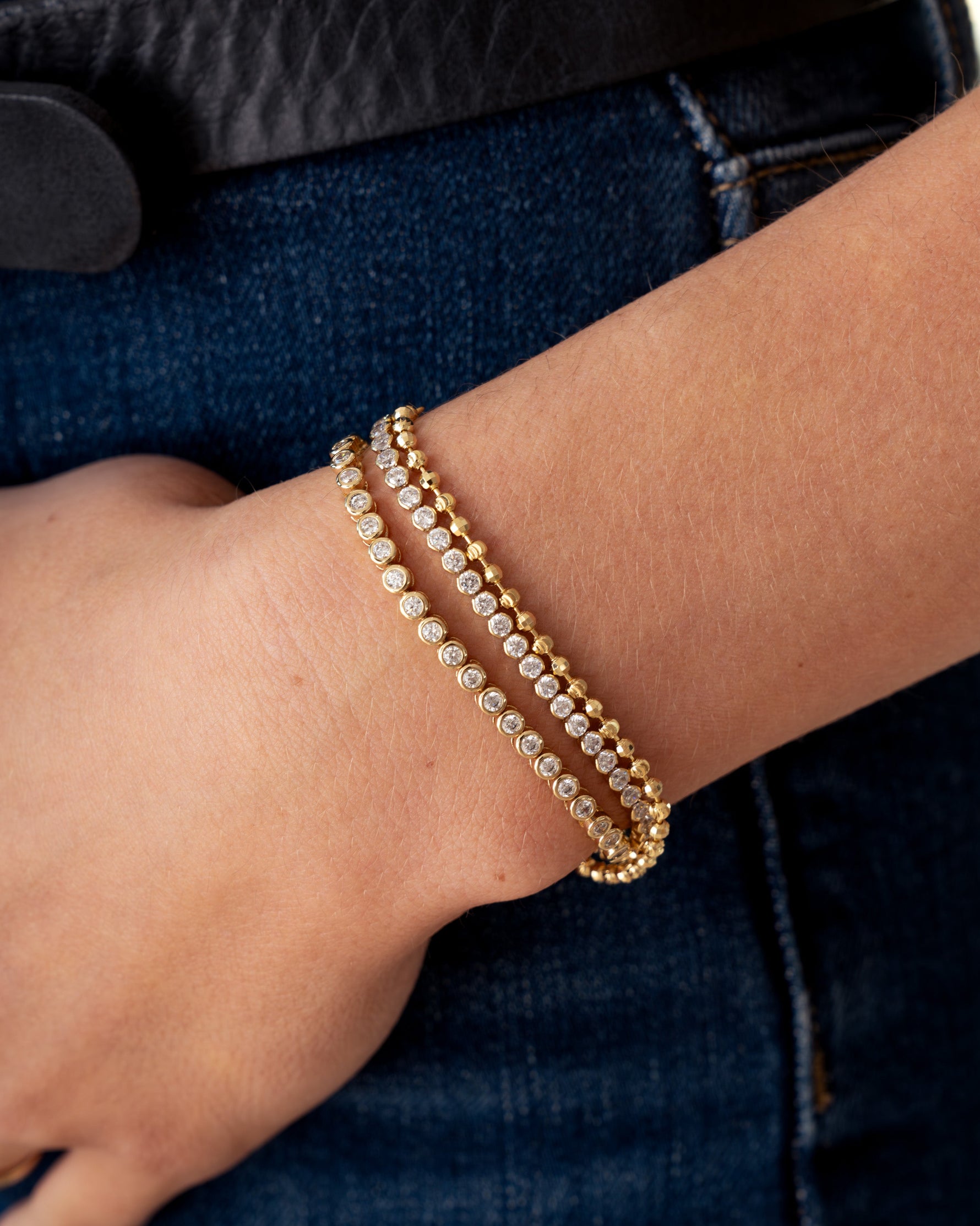 round bezel diamond tennis bracelet gold closeup on model