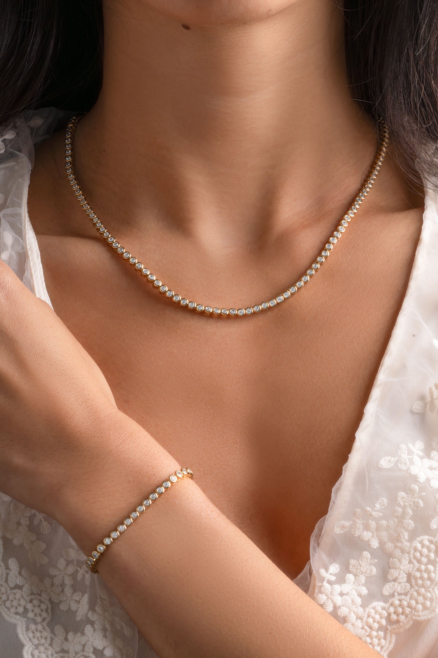 Gold round bezel tennis jewelry bundle from Sami Jewels featuring interconnected chain links and a polished finish.