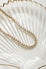 Close-up of a gold 3mm round bezel tennis necklace from Sami Jewels, showcasing the sleek, polished design and fine craftsmanship.