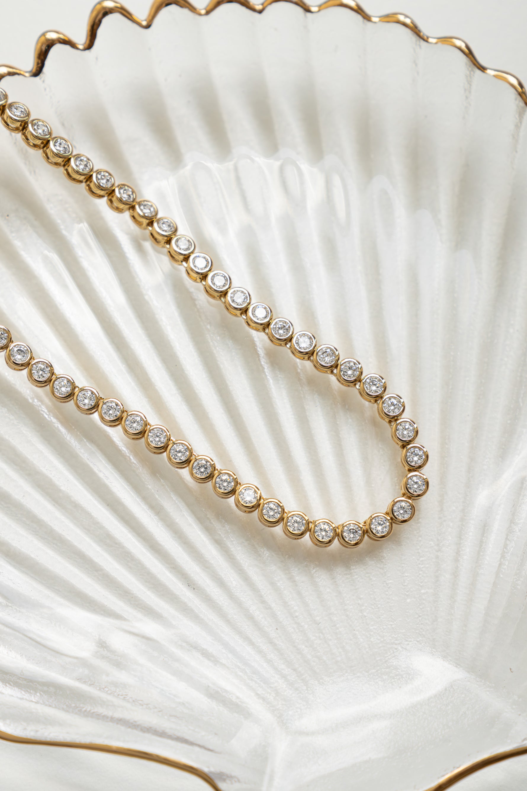Close-up of a gold 3mm round bezel tennis necklace from Sami Jewels, showcasing the sleek, polished design and fine craftsmanship.