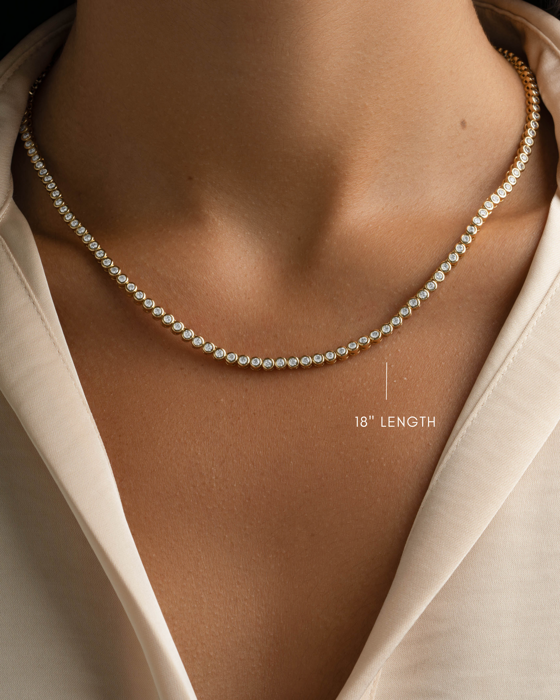 Gold 2.5mm round bezel tennis necklace by Sami Jewels, 18-inch length, with a sleek and elegant design.